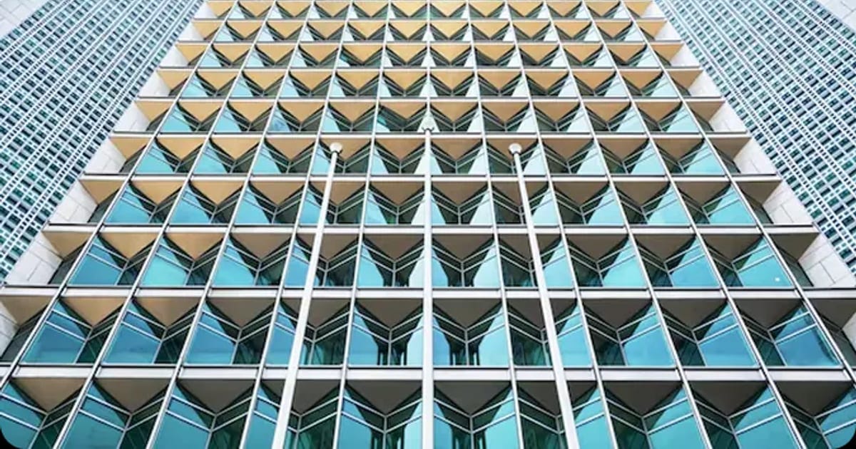 Looking up at a modern high-rise office building